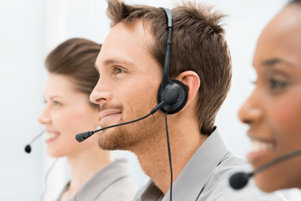 three smiling call-center workers