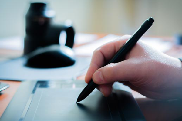 person writing on an electric pad